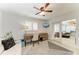 Bright office space with modern desk, ceiling fan, and sliding glass door to living area at 621 Trabue Ave, Punta Gorda, FL 33950