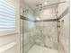 Beautiful tiled shower with glass door enclosure, brushed nickel fixtures, and horizontally laid accent tile at 621 Trabue Ave, Punta Gorda, FL 33950