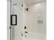 Bright shower featuring a glass door, white subway tile, and black matte shower fixtures at 621 Trabue Ave, Punta Gorda, FL 33950