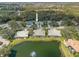 Beautiful aerial view of a house with an arrow to highlight its location near a pond and golf course at 726 Connemara Ct, Venice, FL 34292