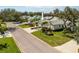 An aerial view of a house featuring nice landscaping, palm trees and greenery at 726 Connemara Ct, Venice, FL 34292