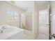 Bright bathroom featuring a vanity, toilet, and glass enclosed shower-tub combo at 726 Connemara Ct, Venice, FL 34292