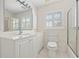 Bathroom with white vanity, toilet and glass enclosed shower at 726 Connemara Ct, Venice, FL 34292