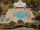 Community pool featuring lounge chairs, tables, and jacuzzi, and decorative landscaping at 726 Connemara Ct, Venice, FL 34292