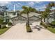 Charming home featuring a three-car garage, well-maintained landscaping, and a beautiful tiled roof at 726 Connemara Ct, Venice, FL 34292