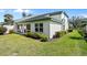 Beautifully landscaped yard with mature trees surrounding an attractive house at 726 Connemara Ct, Venice, FL 34292