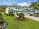 Landscaped front yard with a lush lawn, decorative shrubbery and trees enhancing curb appeal at 726 Connemara Ct, Venice, FL 34292