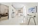 Open-concept design: a kitchen with white cabinets and modern appliances flows into a dining area and workspace at 726 Connemara Ct, Venice, FL 34292
