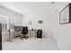 Office space featuring a black desk, dual monitors, and storage cabinets, illuminated by natural light from a window at 726 Connemara Ct, Venice, FL 34292