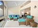 Relaxing sunroom featuring ample seating, ceiling fan, and access to the bedroom with comfortable furniture at 726 Connemara Ct, Venice, FL 34292