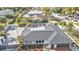 Aerial view of the house shows fenced in yard, screen enclosed lanai, and lush landscape at 20343 Rutherford Ave, Port Charlotte, FL 33952