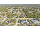 Residential neighborhood with mature trees showcases a home with a pool in the backyard at 20343 Rutherford Ave, Port Charlotte, FL 33952