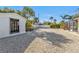 Spacious backyard with decorative rock cover, mature landscaping, white privacy fence and access to screened in porch at 20343 Rutherford Ave, Port Charlotte, FL 33952