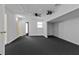 Spacious basement features neutral carpet, ceiling fan and lighting, ready for customization at 20343 Rutherford Ave, Port Charlotte, FL 33952