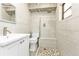 Modern bathroom featuring a tiled shower, toilet, and vanity sink at 20343 Rutherford Ave, Port Charlotte, FL 33952