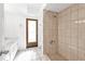 This bathroom features a tiled shower with glass door and a vanity with a white marble counter at 20343 Rutherford Ave, Port Charlotte, FL 33952
