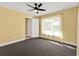 This spacious bedroom features a ceiling fan, closet and large window for natural light at 20343 Rutherford Ave, Port Charlotte, FL 33952