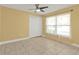 A large bedroom features tile floors, a ceiling fan, and a closet at 20343 Rutherford Ave, Port Charlotte, FL 33952
