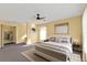 This spacious bedroom boasts a ceiling fan, closet and large window for natural light at 20343 Rutherford Ave, Port Charlotte, FL 33952