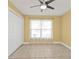 A bright room with neutral walls, a ceiling fan and a large window at 20343 Rutherford Ave, Port Charlotte, FL 33952