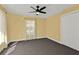 This spacious bedroom has a ceiling fan and a closet at 20343 Rutherford Ave, Port Charlotte, FL 33952