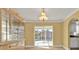 Dining room features wood-look floors, a sliding glass door and a built in cabinet at 20343 Rutherford Ave, Port Charlotte, FL 33952