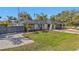 Charming one-story home features a well-kept lawn, mature trees, and a classic driveway at 20343 Rutherford Ave, Port Charlotte, FL 33952