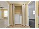 Bright laundry area featuring a washer and dryer tucked behind curtains at 20343 Rutherford Ave, Port Charlotte, FL 33952