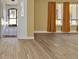View of living room with hardwood flooring, neutral paint, large windows, and arched entryways at 20343 Rutherford Ave, Port Charlotte, FL 33952