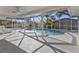 Screened-in lanai with a refreshing swimming pool and lush landscaping at 20343 Rutherford Ave, Port Charlotte, FL 33952
