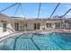 Gorgeous pool with clear blue water inside screened-in lanai at 20343 Rutherford Ave, Port Charlotte, FL 33952