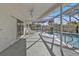Inviting pool area with covered patio seating surrounded by tropical landscaping at 20343 Rutherford Ave, Port Charlotte, FL 33952