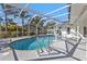 Captivating in-ground pool inside screened lanai perfect for enjoying sunny days at 20343 Rutherford Ave, Port Charlotte, FL 33952