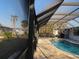 View of screened pool from the house's covered outdoor area and pool at 105 Leland Se St, Port Charlotte, FL 33952