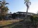 A screened-in pool enclosure with palms provides an outdoor relaxation space at 105 Leland Se St, Port Charlotte, FL 33952