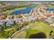 An aerial view showcasing houses in a golf course community, with serene lakes and lush green fairways at 1321 Eagles Flight Way, North Port, FL 34287