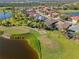 An aerial view of a residential community with lush landscaping, water features, and a well-maintained golf course at 1321 Eagles Flight Way, North Port, FL 34287