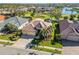 Aerial view of a luxurious neighborhood showcasing beautiful homes, mature landscaping, and a serene lake at 1321 Eagles Flight Way, North Port, FL 34287