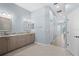 Bright bathroom features dual sinks, granite countertops, and tile flooring leading to the bedroom at 1321 Eagles Flight Way, North Port, FL 34287