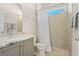 Well-lit bathroom features a tiled shower and vanity with a stone countertop at 1321 Eagles Flight Way, North Port, FL 34287