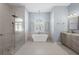 Luxurious bathroom with a freestanding tub, walk-in shower, stylish vanity, and modern fixtures at 1321 Eagles Flight Way, North Port, FL 34287