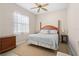Bedroom featuring neutral colors, ceiling fan, and wooden furniture at 1321 Eagles Flight Way, North Port, FL 34287