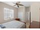 Comfortable bedroom with ceiling fan, closet and a bright window overlooking the grounds at 1321 Eagles Flight Way, North Port, FL 34287