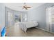 Comfortable bedroom with natural light, tile flooring, and direct access to outdoor living space at 1321 Eagles Flight Way, North Port, FL 34287