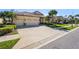 Charming home with a 3 car garage, a tile roof, and lush landscaping at 1321 Eagles Flight Way, North Port, FL 34287