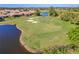 An aerial view of a golf course with sand traps, a lake, and abundant wildlife, highlighting a golfer's paradise at 1321 Eagles Flight Way, North Port, FL 34287