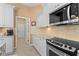 Close up of kitchen features stainless steel oven, microwave, and tiled backsplash at 1321 Eagles Flight Way, North Port, FL 34287