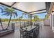 Inviting outdoor seating area with palm trees and a pool view for relaxing or entertaining in a tropical setting at 1321 Eagles Flight Way, North Port, FL 34287