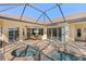 Screened-in lanai showcasing a spa and pool with outdoor dining space at 1321 Eagles Flight Way, North Port, FL 34287