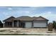 Two-story home with a modern elevation and a two-car garage with green grass and blue skies above at 14735 Keystone Blvd, Port Charlotte, FL 33981